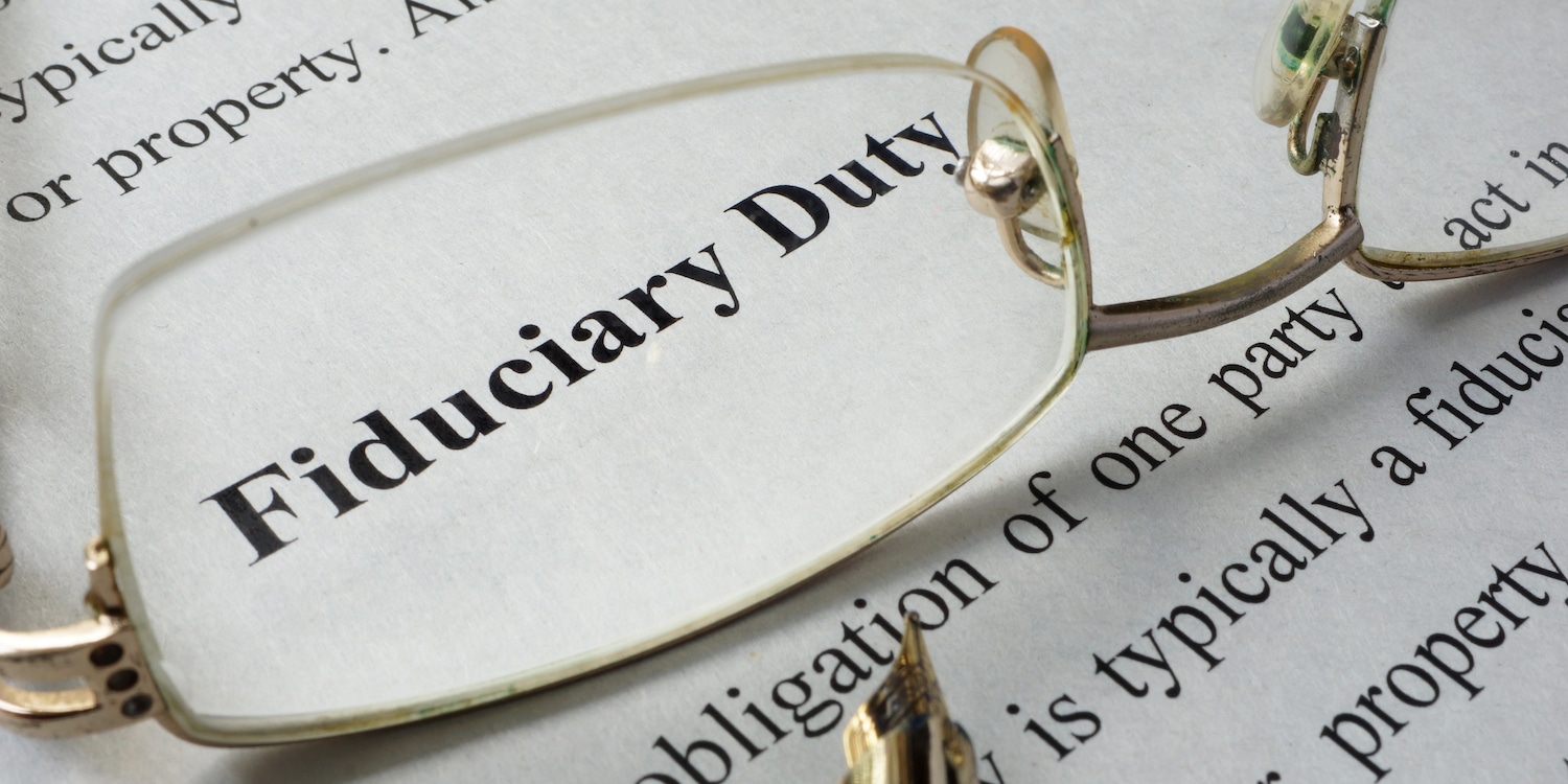 Glasses on a page with the definition of fiduciary duty