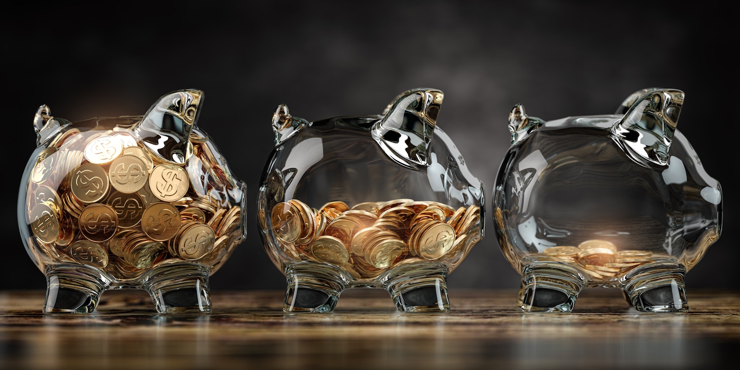 A glass piggy bank with decreasing amounts of money, representing inflation